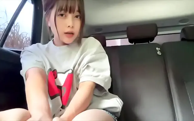 Fingering herself to climax in a parked car with quiet moans and no one around but her